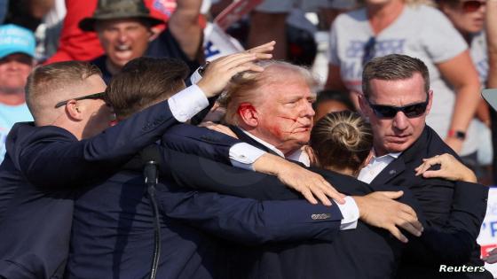 Republican presidential candidate and former U.S. President Donald Trump is assisted by the Secret Service after gunfire rang out during a campaign rally at the Butler Farm Show in Butler, Pennsylvania, U.S., July 13, 2024. REUTERS/Brendan McDermid